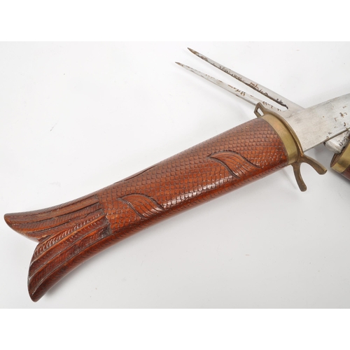 333 - A vintage 20th century Indian fish carving knife set housed in a sheath carved as a fish with brass ... 