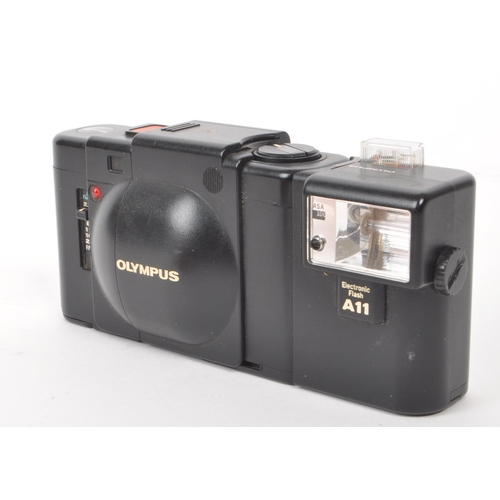 335 - Olympus - XA - A circa 1980s Olympus XA 35mm rangefinder camera. The camera in black colourway, havi... 