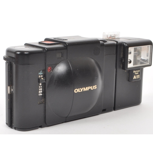 335 - Olympus - XA - A circa 1980s Olympus XA 35mm rangefinder camera. The camera in black colourway, havi... 