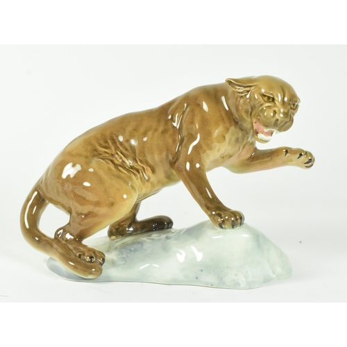 34 - A 20th century Beswick gloss finish figurine of a puma on a rock.
20cm x 15cm approx.