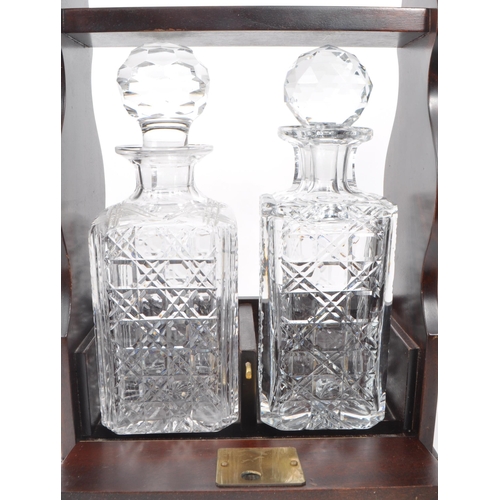 343 - A 20th century crystal cut glass decanter tantalus. The tantalus having mahogany body, with hinged l... 