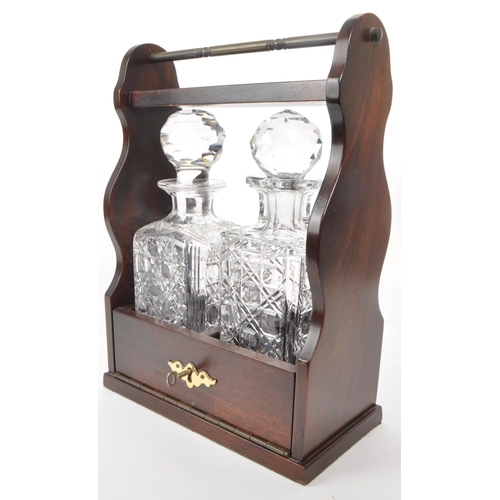 343 - A 20th century crystal cut glass decanter tantalus. The tantalus having mahogany body, with hinged l... 