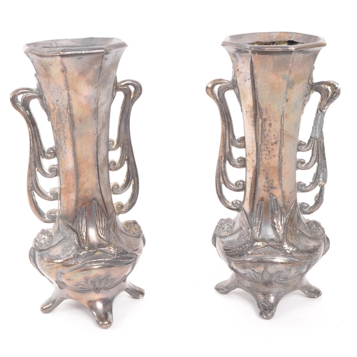 349 - A pair of early 20th Century Art Nouveau pewter German vases raised on four legs. Having rounded squ... 