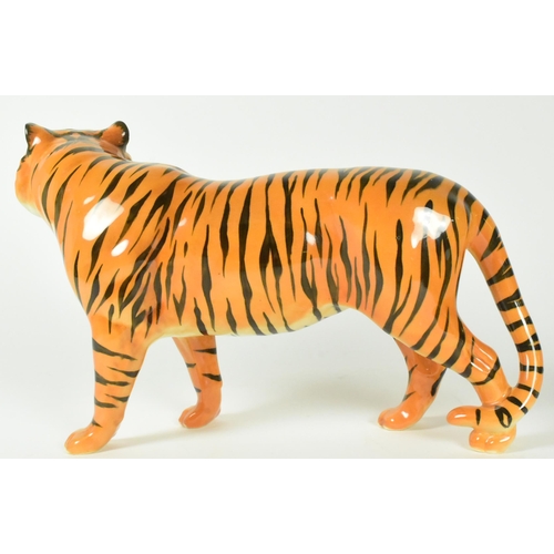 35 - Two gloss finish 20th century Beswick figurines including a cheetah and a tiger.