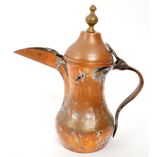 351 - A 19th Century Middle Eastern Arabic brass teapot / coffee pot having hinged weighted lid with round... 