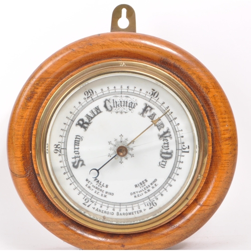 376 - A late 19th century Victorian aneroid barometer, mounted on an oak plinth base, with brass mounts an... 