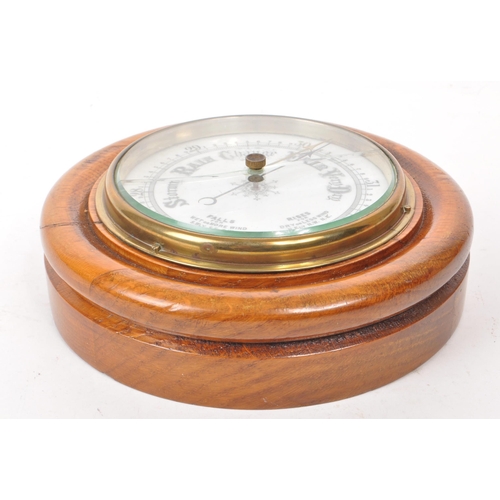 376 - A late 19th century Victorian aneroid barometer, mounted on an oak plinth base, with brass mounts an... 