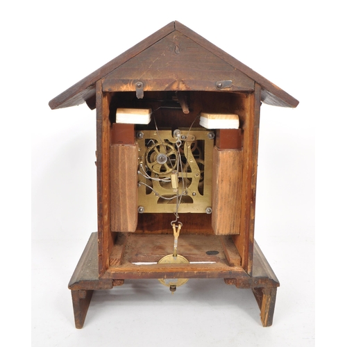 378 - An early 20th century carved wooden mantel cuckoo clock, in the style of black forest. Featuring an ... 