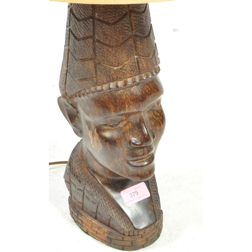 379 - A West African believed Nigerian ebony wood carved bust sculpture lamp. Complete with shade atop.... 