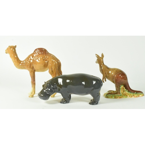 38 - A selection of Beswick glossy finish 20th century animal figurines. Includes a camel, hippo, and kan... 