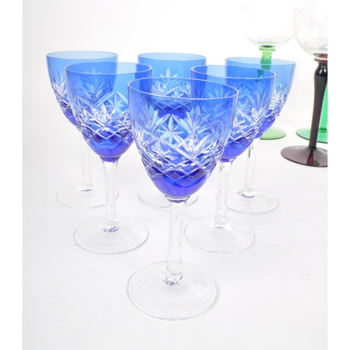 383 - Large collection of vintage 20th century coloured crystal cut glass drinking glasses. Fleur de lis p... 