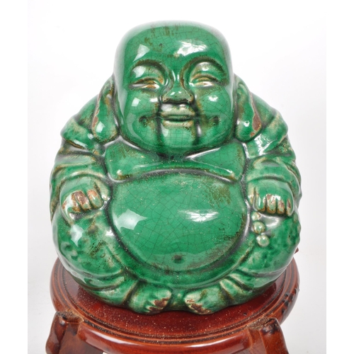 384 - A collection of 20th century of Chinese Asian curious. Including glazed laughing Buddha, soapstone v... 