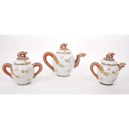 385 - Three vintage 20th century Japanese dragon porcelain teapots. Having white ground with high reflie d... 