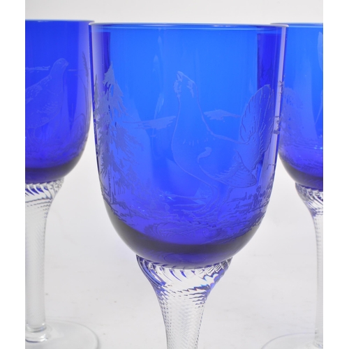 387 - A collection of mid century cobalt blue hand blown glasses / goblets. Featuring etched birds on the ... 