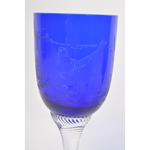 387 - A collection of mid century cobalt blue hand blown glasses / goblets. Featuring etched birds on the ... 