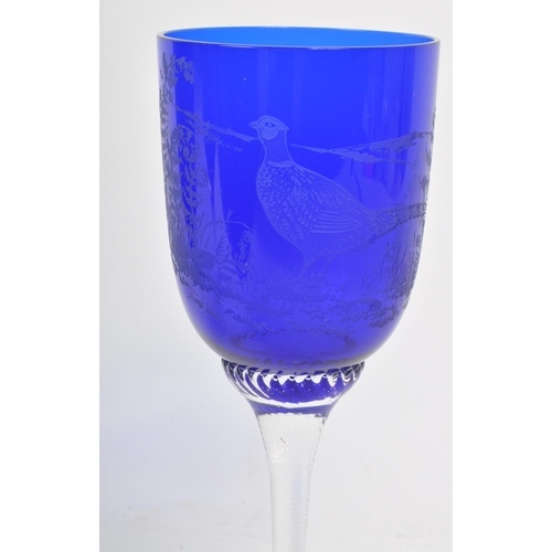 387 - A collection of mid century cobalt blue hand blown glasses / goblets. Featuring etched birds on the ... 