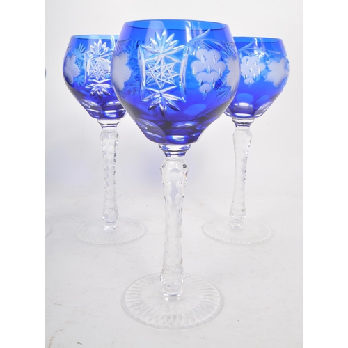 388 - A collection of six vintage mid century cobalt blue cut crystal wine glasses, featuring a heavily cu... 