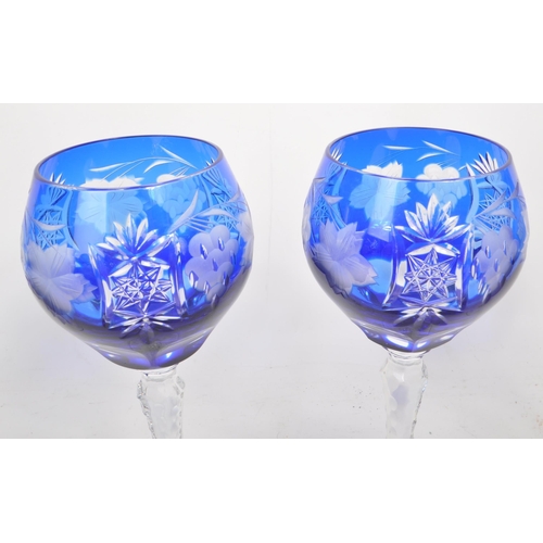 388 - A collection of six vintage mid century cobalt blue cut crystal wine glasses, featuring a heavily cu... 