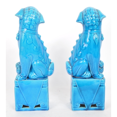 390 - Two vintage 20th century blue glazed Chinese Guardian Temple Fu Dogs. Raised on pedestal bases, with... 