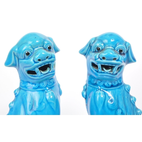 390 - Two vintage 20th century blue glazed Chinese Guardian Temple Fu Dogs. Raised on pedestal bases, with... 