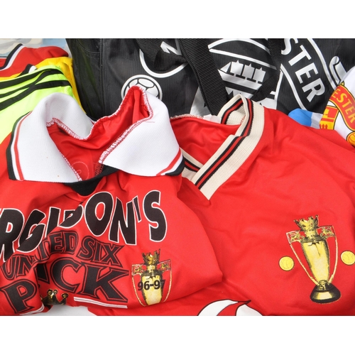 394 - A collection of 21st century Manchester United football shirts and two kit bags, including fan shirt... 