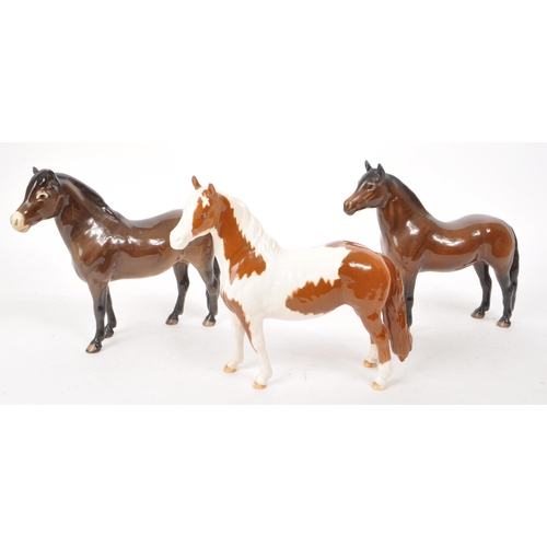 42 - Beswick - A collection of three 20th-century china horse figurines, comprising of a Skewbald Pinto p... 