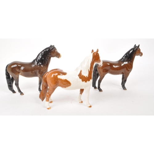 42 - Beswick - A collection of three 20th-century china horse figurines, comprising of a Skewbald Pinto p... 