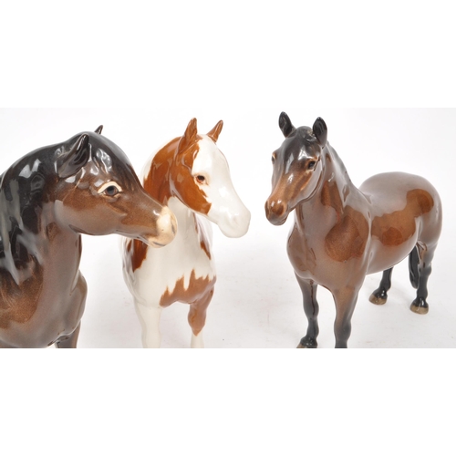 42 - Beswick - A collection of three 20th-century china horse figurines, comprising of a Skewbald Pinto p... 