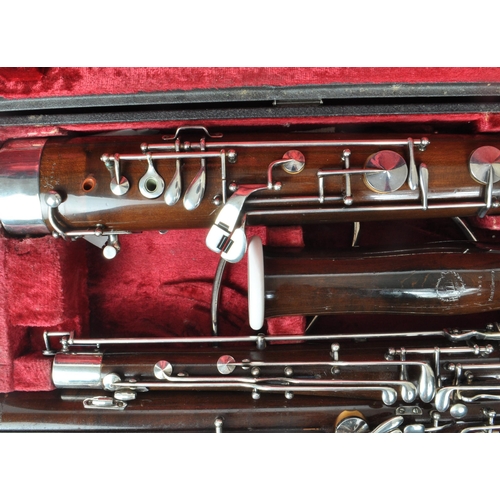 426 - G. H. Hüller Schöneck - An early 20th century German Bassoon with metal mounts, no.56494. Housed wit... 