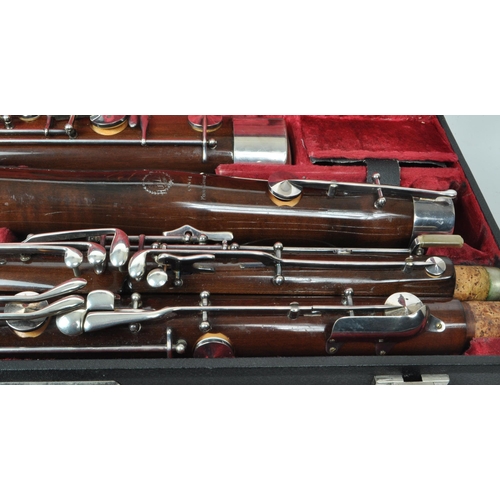 426 - G. H. Hüller Schöneck - An early 20th century German Bassoon with metal mounts, no.56494. Housed wit... 