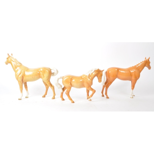 43 - Beswick - A collection of three 20th-century china Palomino horse pony figurines, comprising of two ... 