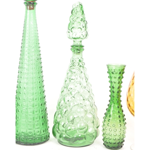 450 - A collection of 20th century vintage glas to include a variety of empoli manner stoppered genie bott... 