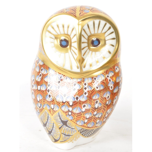 466 - Royal Crown Derby - Two 21st century porcelain owl paperweights, comprised of a 2005 MMV orange and ... 