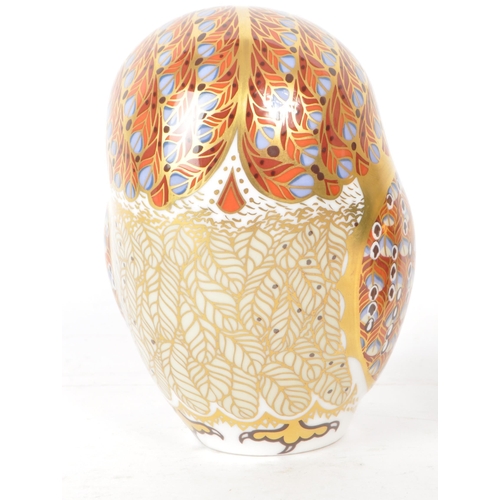 466 - Royal Crown Derby - Two 21st century porcelain owl paperweights, comprised of a 2005 MMV orange and ... 