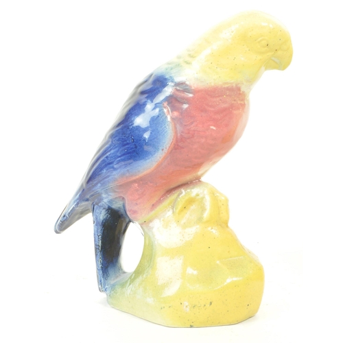 467 - A pair of 19th century Victorian ceramic bird parrot figurines, with a yellow, pink and blue glaze. ... 