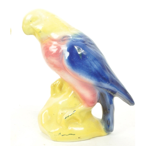 467 - A pair of 19th century Victorian ceramic bird parrot figurines, with a yellow, pink and blue glaze. ... 