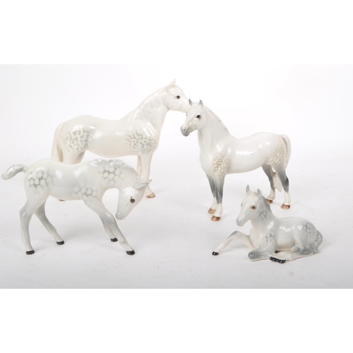 48 - Beswick - A collection of four 20th century dapple grey horse figures, comprising of: a Welsh Mounta... 