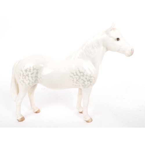 48 - Beswick - A collection of four 20th century dapple grey horse figures, comprising of: a Welsh Mounta... 