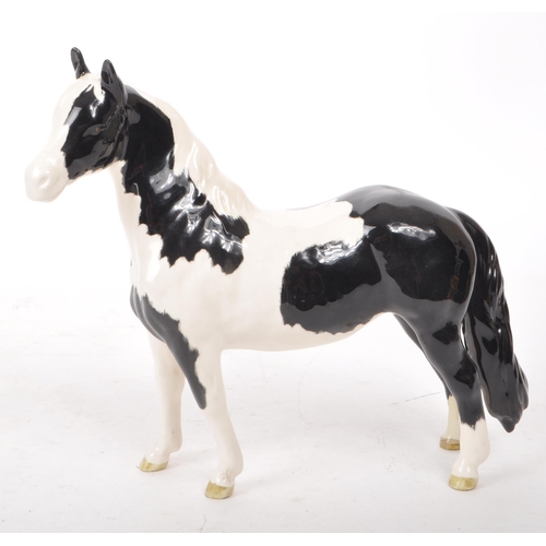 51 - Beswick - A late 20th-century porcelain Piebald Pinto pony / horse figurine no. 1373. Featuring blac... 