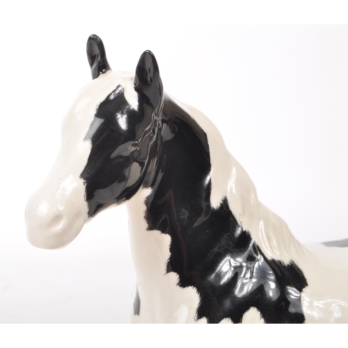 51 - Beswick - A late 20th-century porcelain Piebald Pinto pony / horse figurine no. 1373. Featuring blac... 