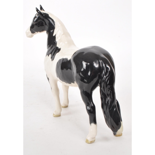 51 - Beswick - A late 20th-century porcelain Piebald Pinto pony / horse figurine no. 1373. Featuring blac... 