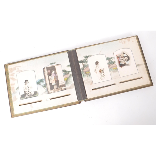 537 - A collection of early 20th-century Japanese hand-coloured postcards and photographs, housed within a... 