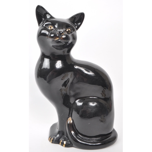 60 - Beswick - Two 20th-century glazed porcelain cat figures, comprising of a sitting black cat, no. 1561... 