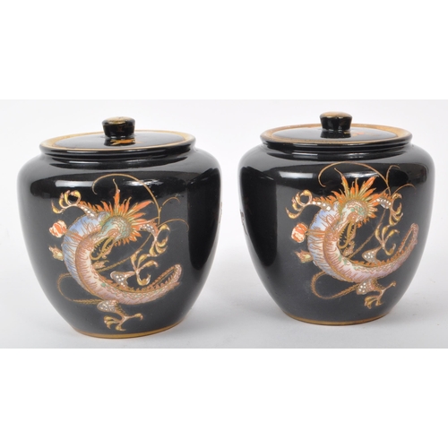 76 - Crown Devon - Fieldings - Two early 20th-century ceramic lidded tobacco jars / pots, with a black co... 