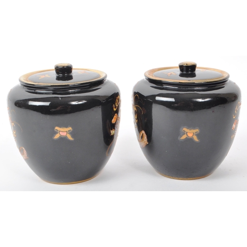 76 - Crown Devon - Fieldings - Two early 20th-century ceramic lidded tobacco jars / pots, with a black co... 