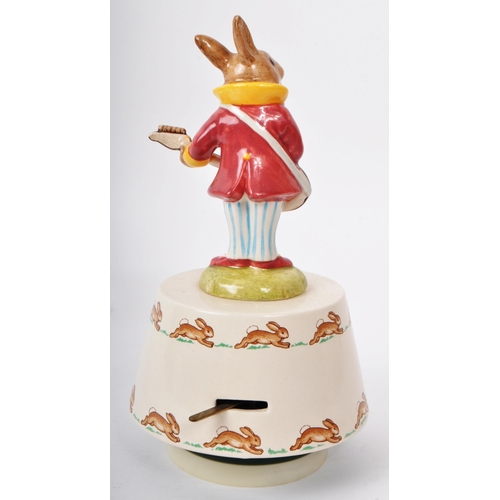 78 - Royal Doulton - Bunnykins - A 20th century porcelain 'Hey Jude' music box. Featuring a bunny in a pu... 