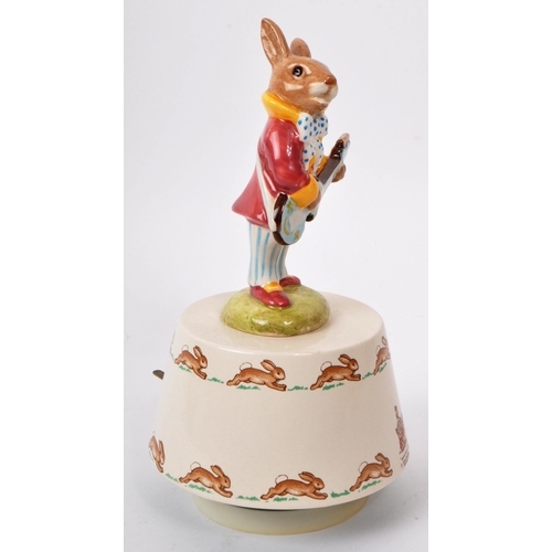 78 - Royal Doulton - Bunnykins - A 20th century porcelain 'Hey Jude' music box. Featuring a bunny in a pu... 