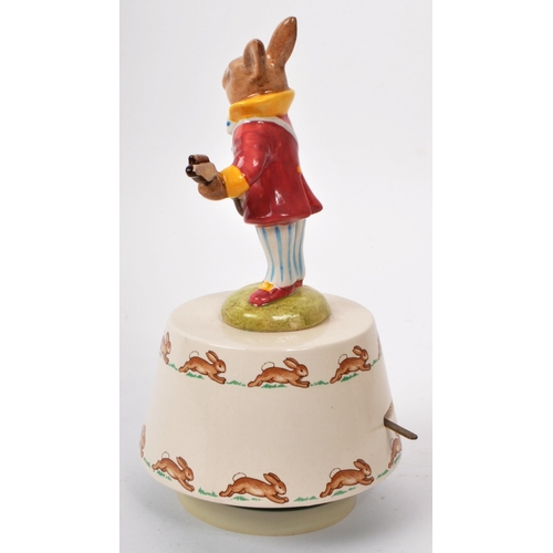 78 - Royal Doulton - Bunnykins - A 20th century porcelain 'Hey Jude' music box. Featuring a bunny in a pu... 