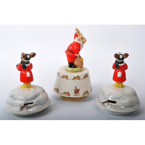 81 - Royal Doulton - Bunnykins - Three 20th-century Christmas music boxes. Comprising of two 'Carol Singe... 