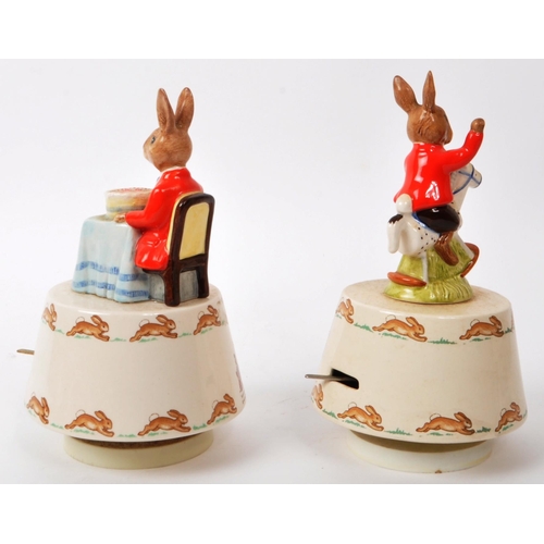 83 - Royal Doulton - Bunnykins - Two 20th-century porcelain music boxes. Comprising of 'Rock-A-Bye Baby' ... 